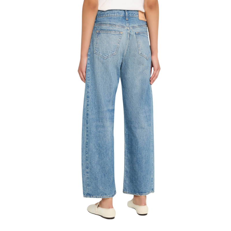 Light blue jeans worn by a person on a white background