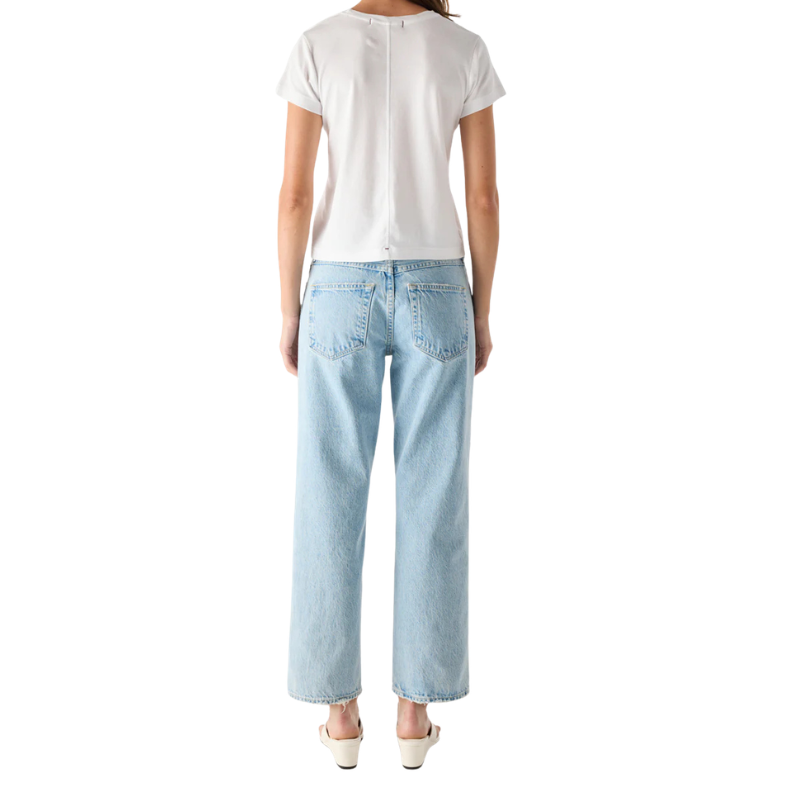 Person wearing a white t-shirt and light blue jeans on a white background