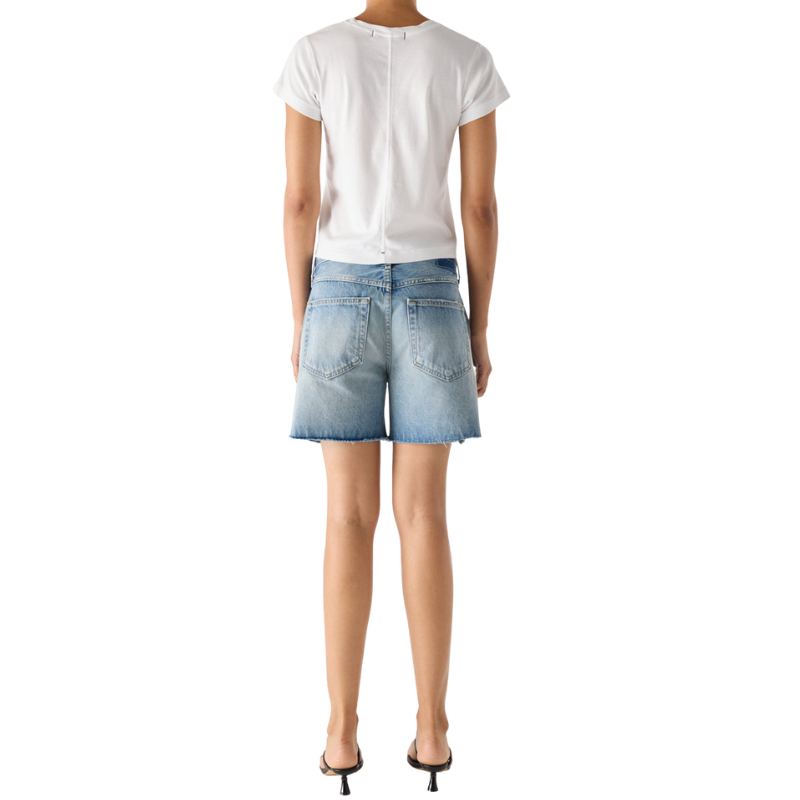 Person wearing a white t-shirt and denim shorts on a white background