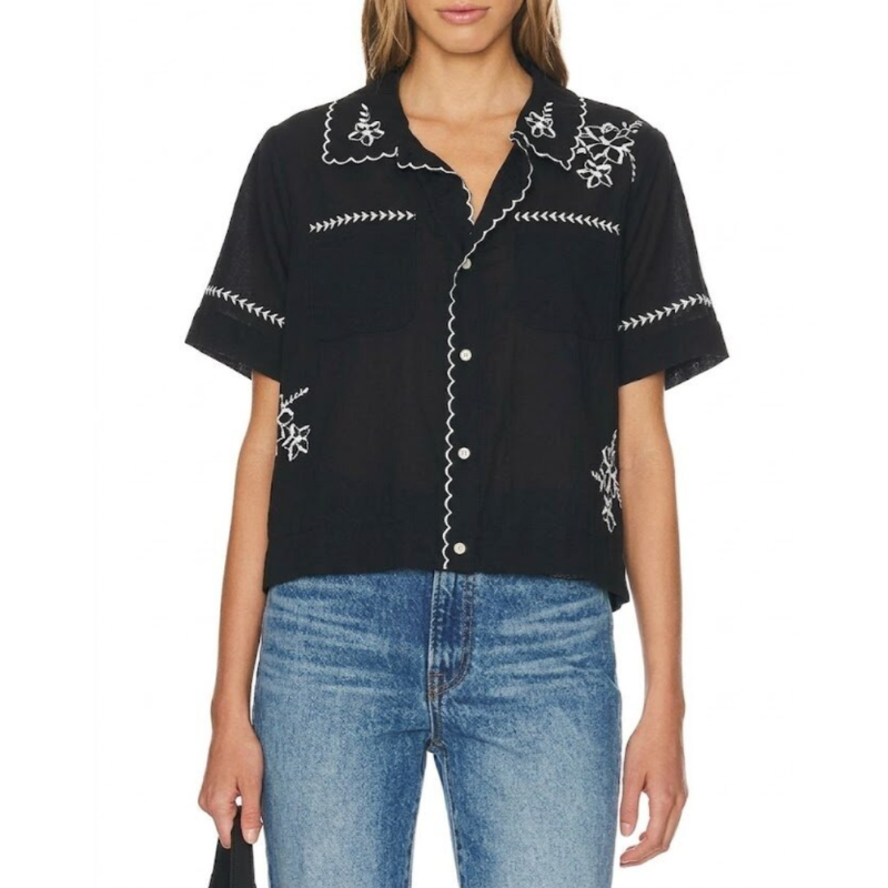 Black embroidered shirt worn by a person on a white background