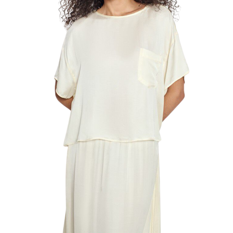 Woman wearing a white dress with a plain background