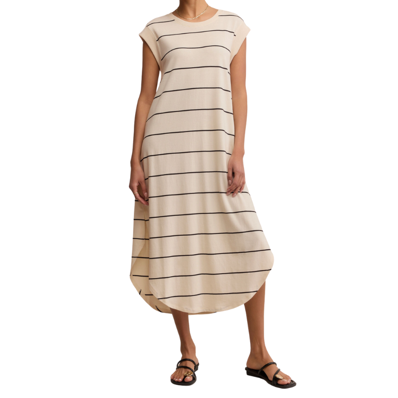 Beige and brown striped dress worn by a person on a white background