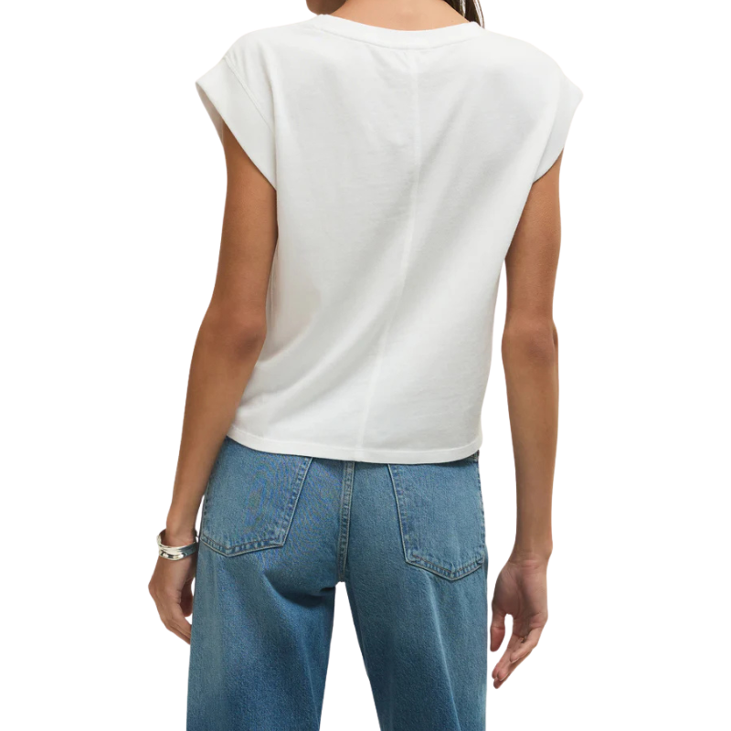 Person wearing a white sleeveless top and blue jeans on a white background
