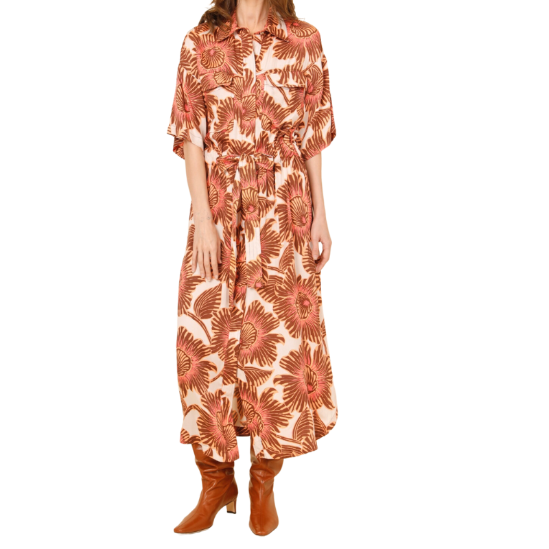 Woman wearing a floral dress with orange and white pattern on a white background
