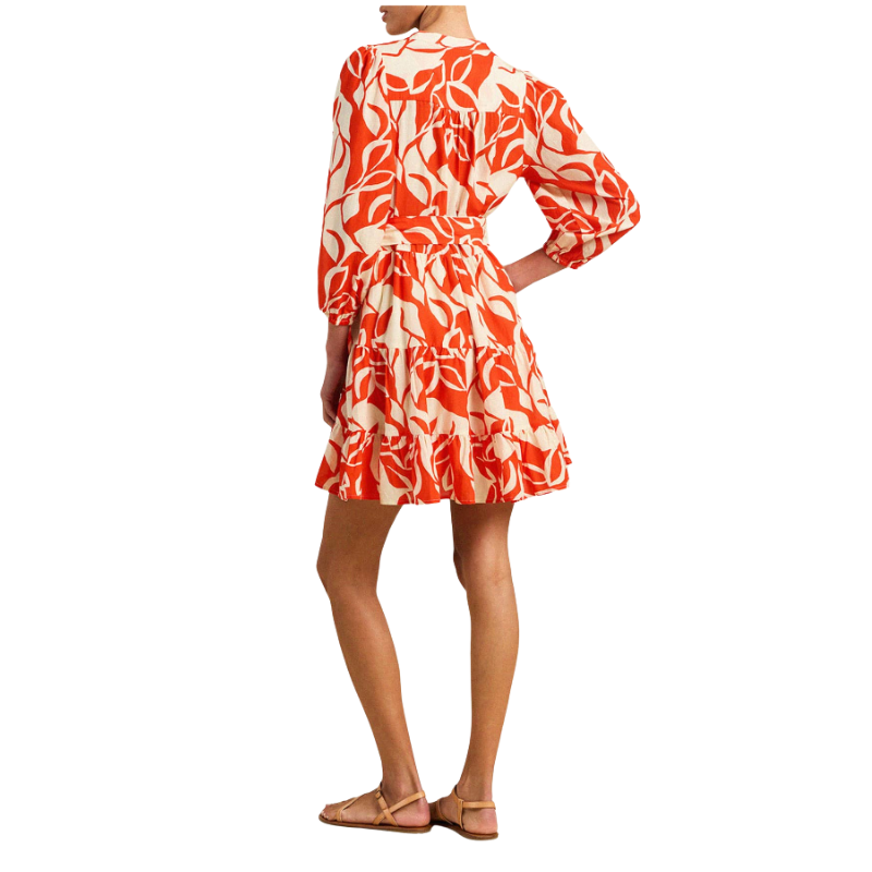 Woman wearing a red and white floral dress on a white background