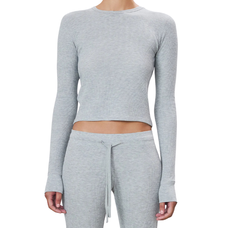 Gray long-sleeve crop top and pants set on a white background