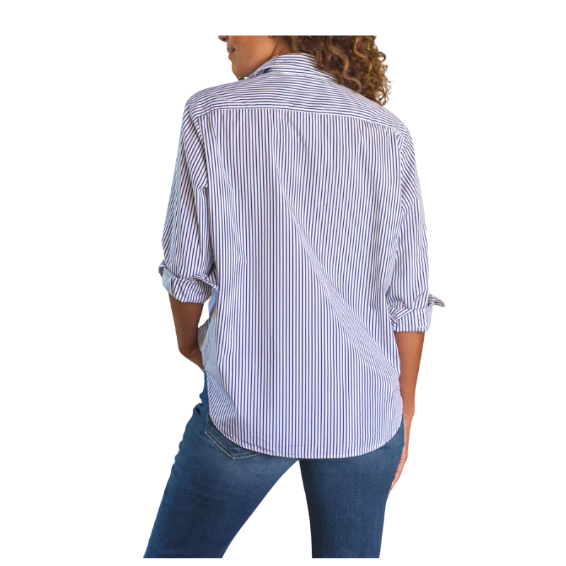 Woman wearing a blue and white striped shirt with rolled-up sleeves on a white background