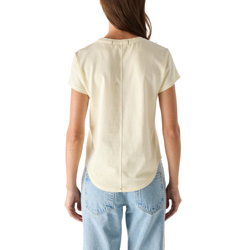 Person wearing a beige blouse and light blue jeans on a white background