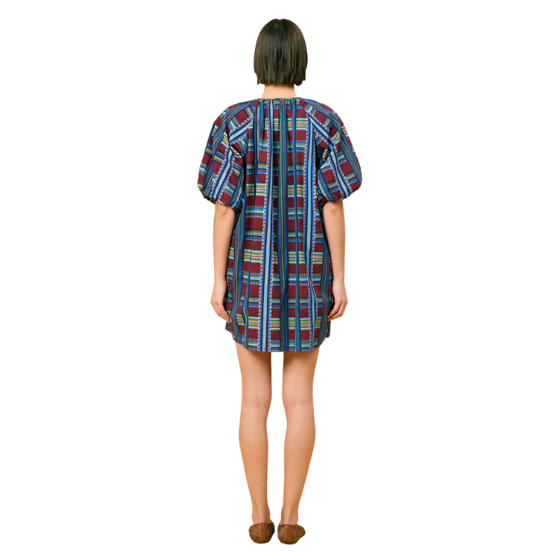 Woman wearing a plaid dress on a white background