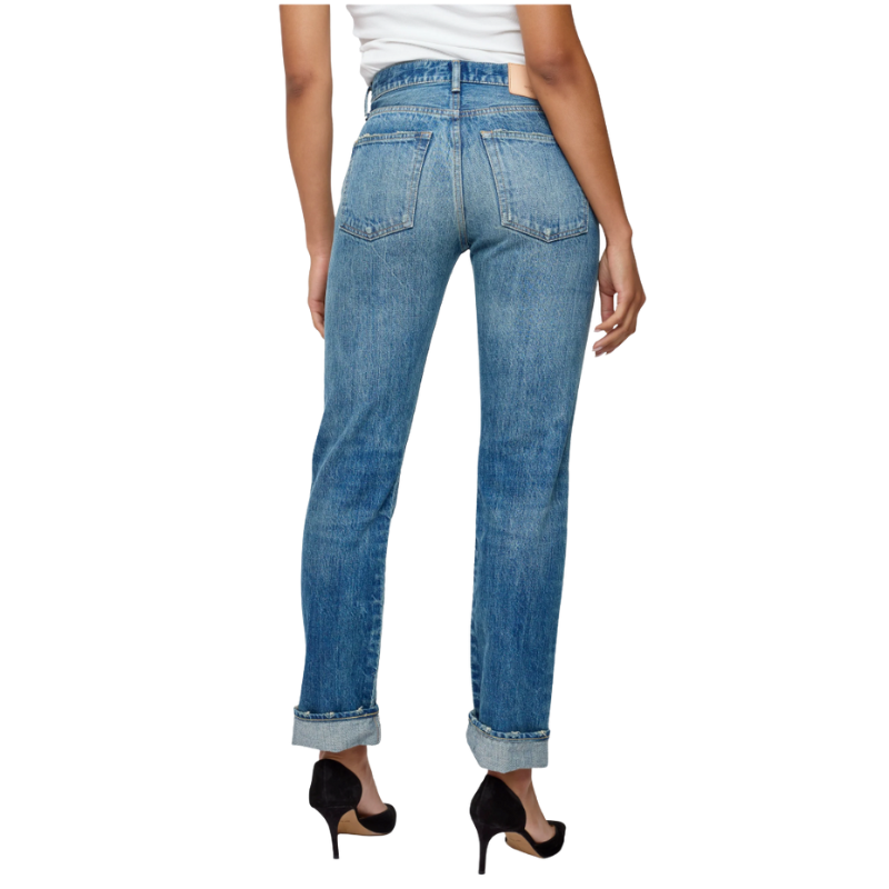 Blue jeans worn by a person on a white background