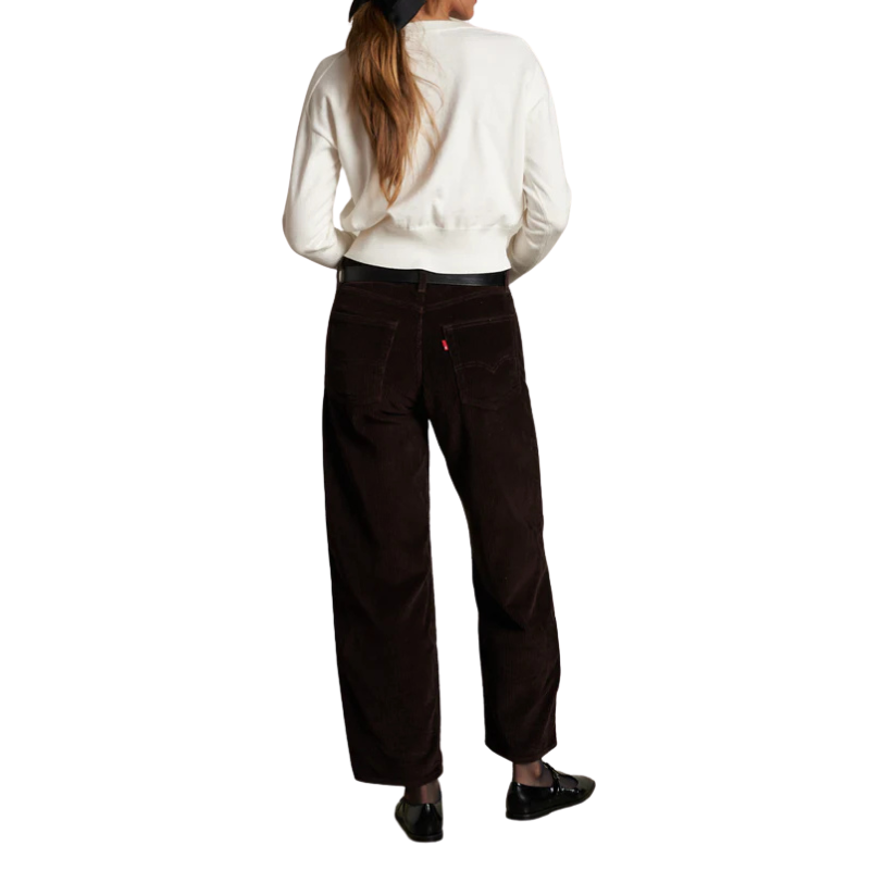 Person wearing a white shirt and dark pants on a white background