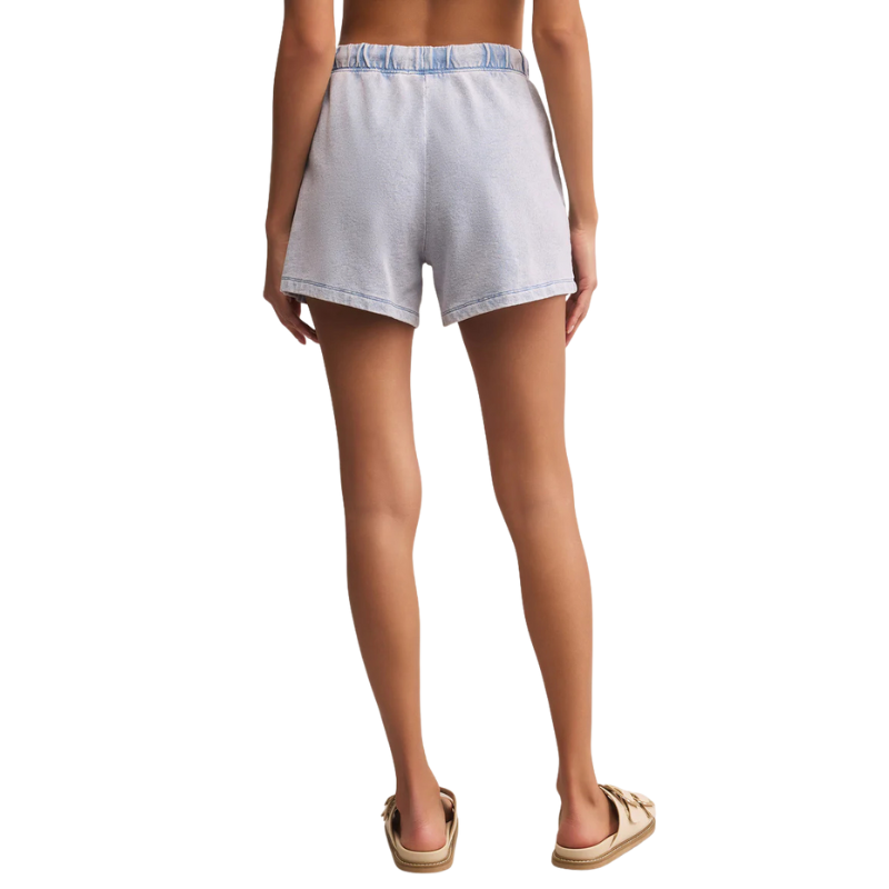 Person wearing light blue shorts on a white background