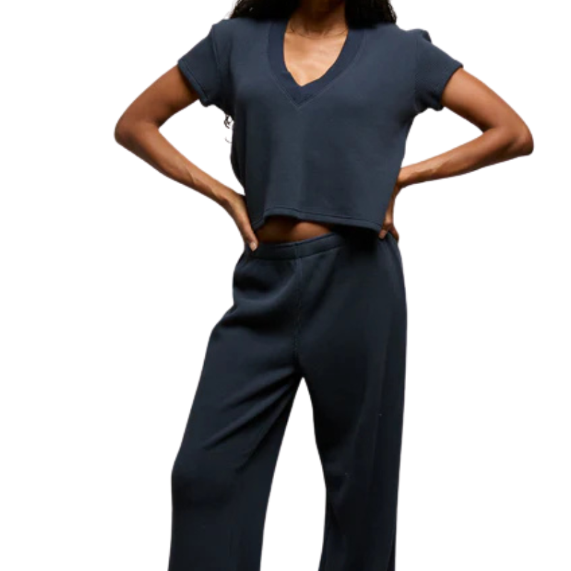 Person wearing a navy blue outfit on a white background