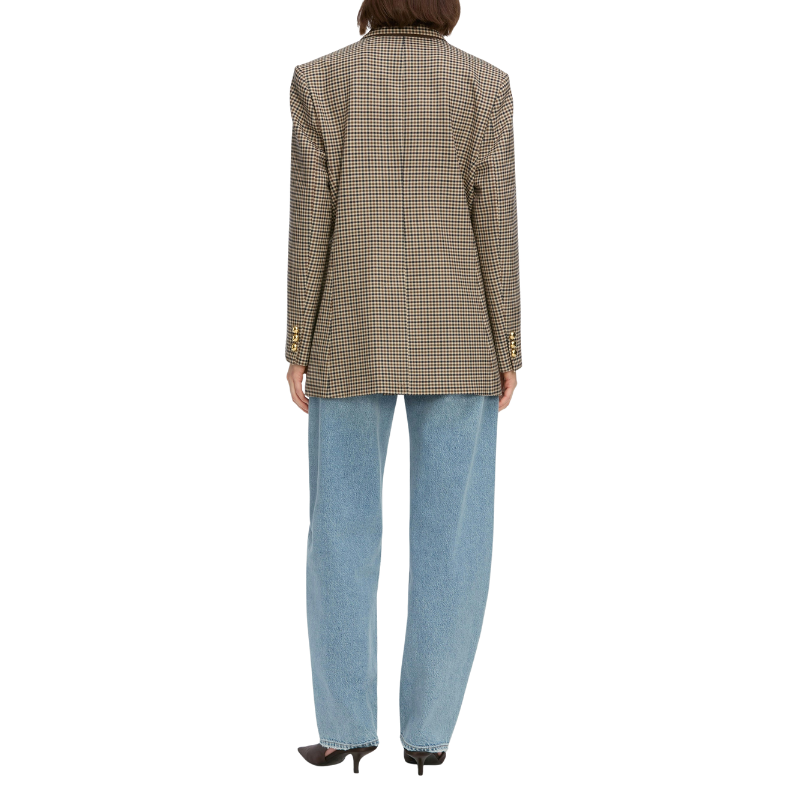 Person wearing a plaid blazer and light blue jeans on a white background
