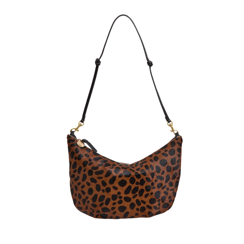 Leopard print handbag with a black strap on a white background