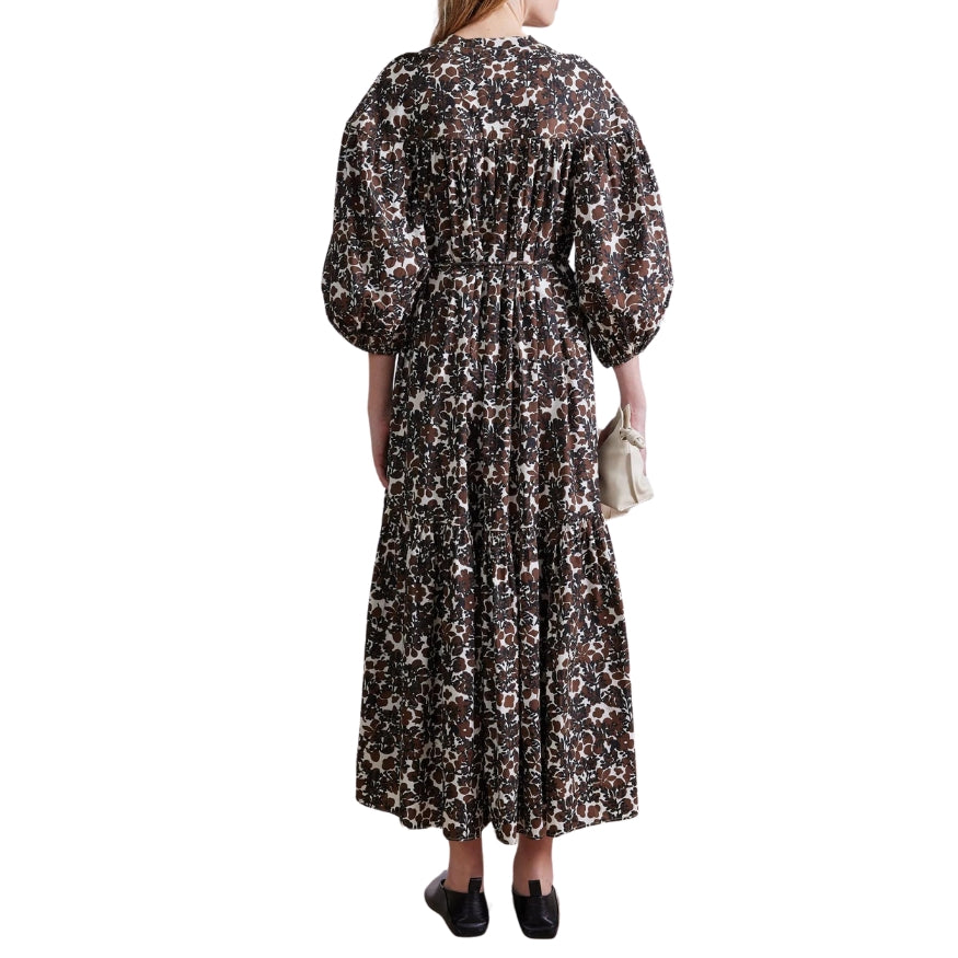 Woman wearing a floral dress with long sleeves on a white background