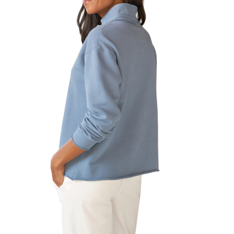 Person wearing a light blue long-sleeve shirt on a white background