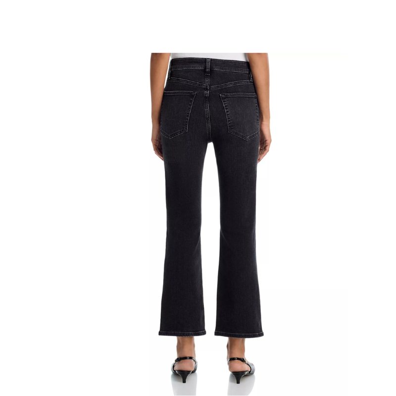 Black jeans worn by a person on a white background