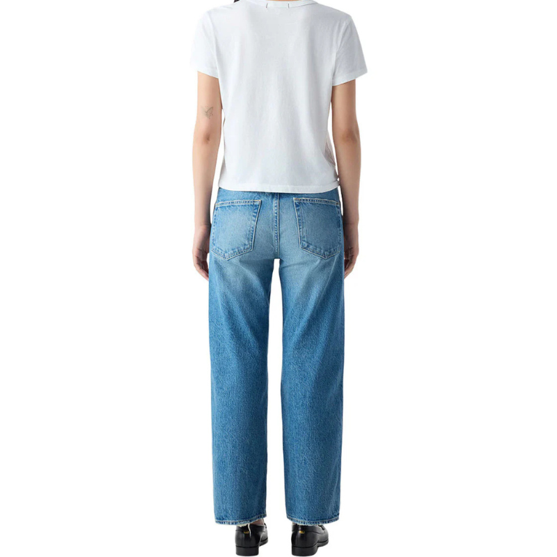Person wearing blue jeans and a white t-shirt on a white background