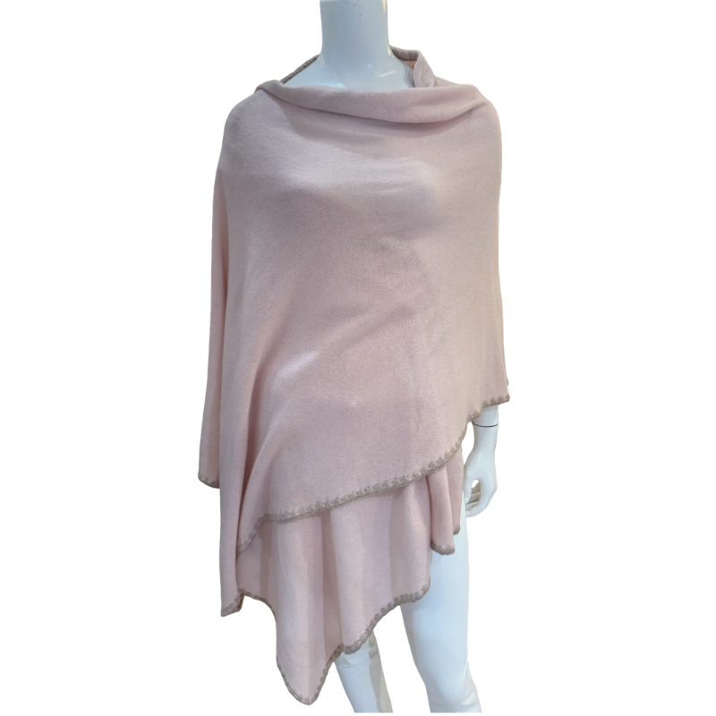 Mannequin wearing a light pink poncho on a white background