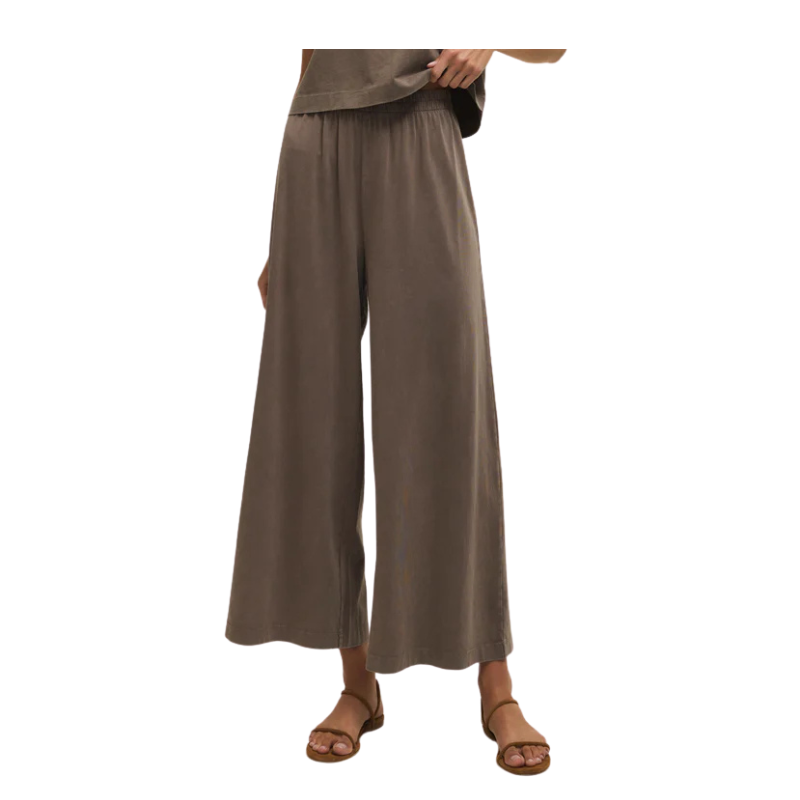 Brown wide-leg pants worn by a person on a white background