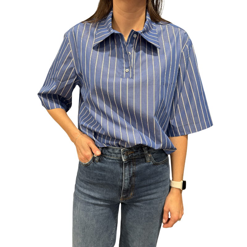 Person wearing a blue and white striped shirt and jeans on a white background