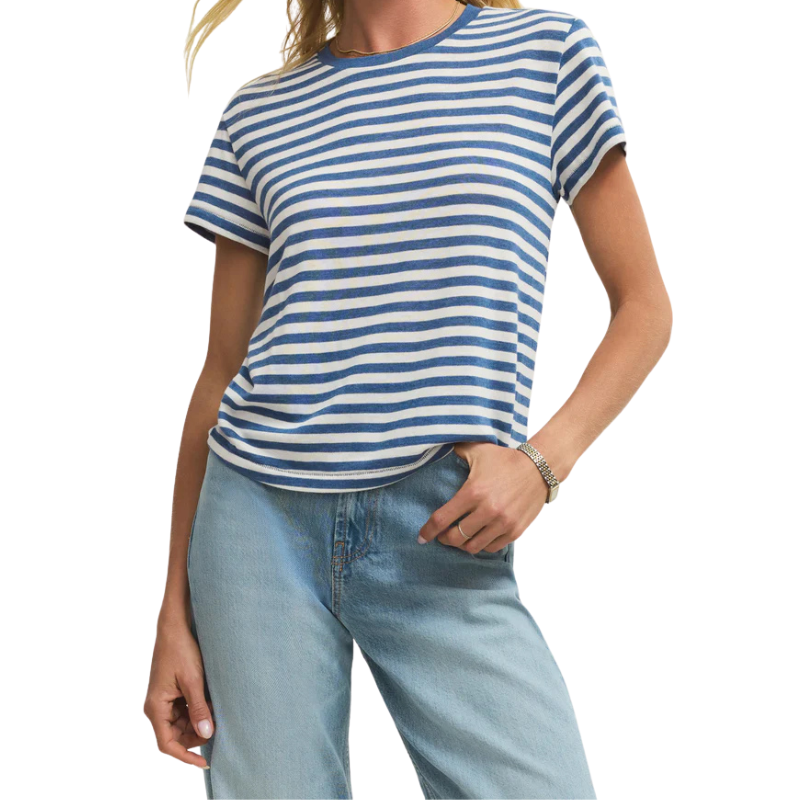 Person wearing a blue and white striped t-shirt and light blue jeans on a white background
