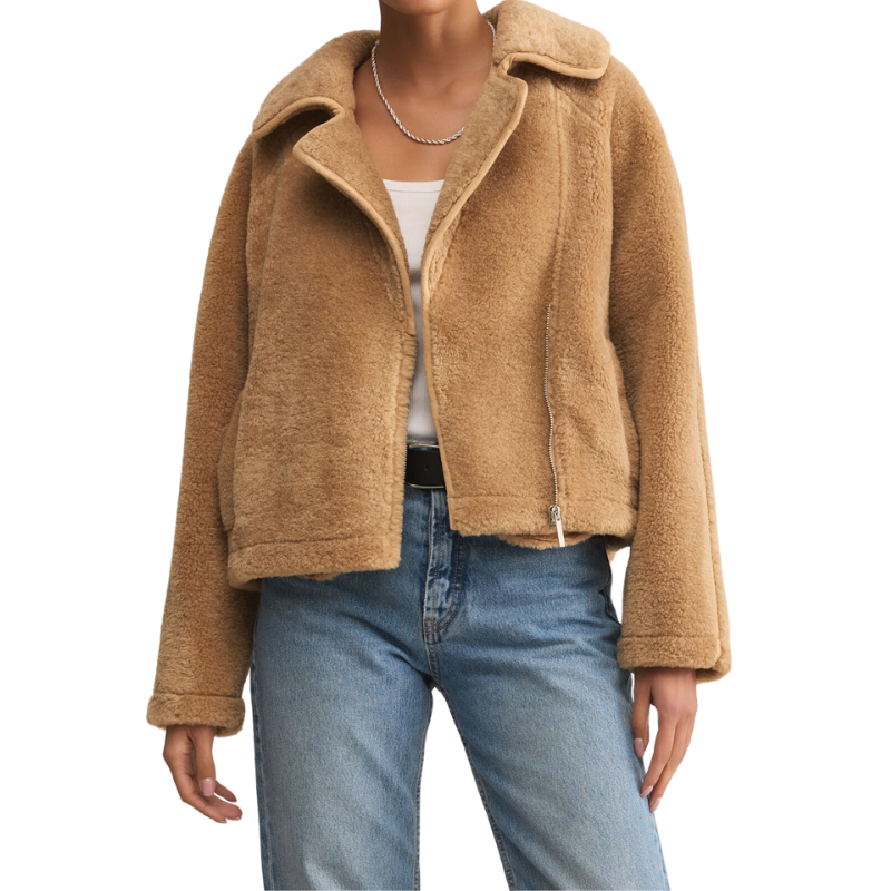 Person wearing a brown jacket and blue jeans on a white background