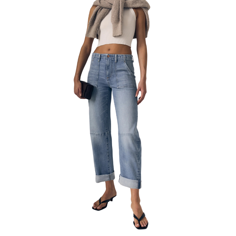 Person wearing light blue jeans on a white background
