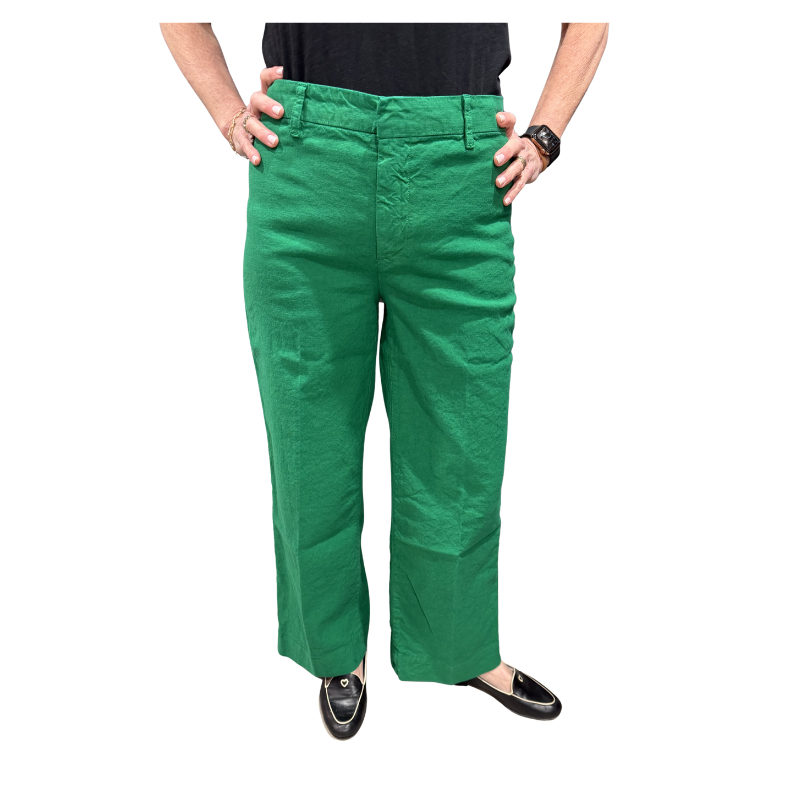 Green pants worn by a person on a white background