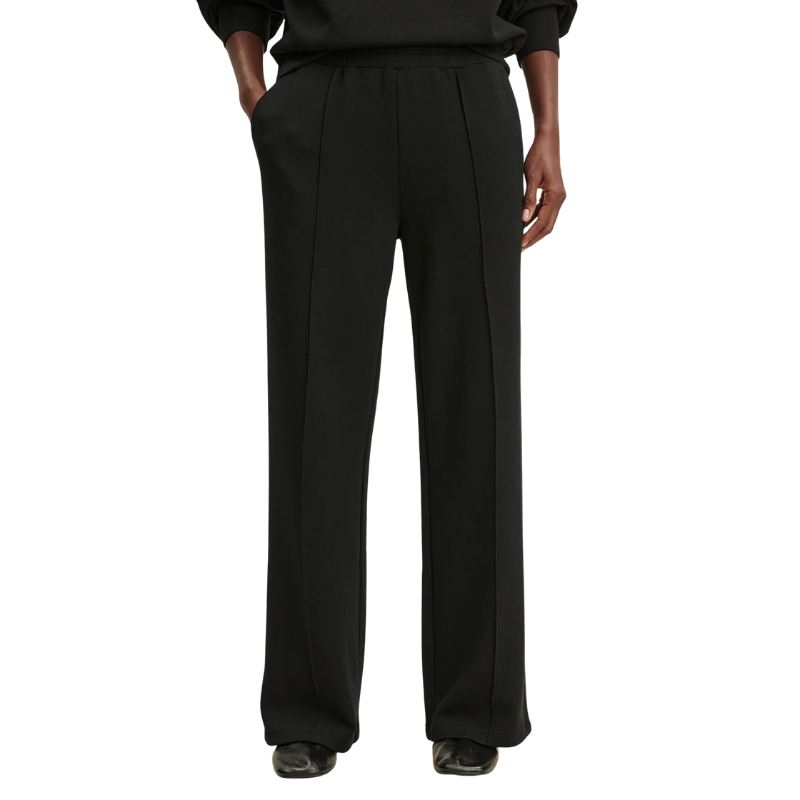 Black pants worn by a person on a white background