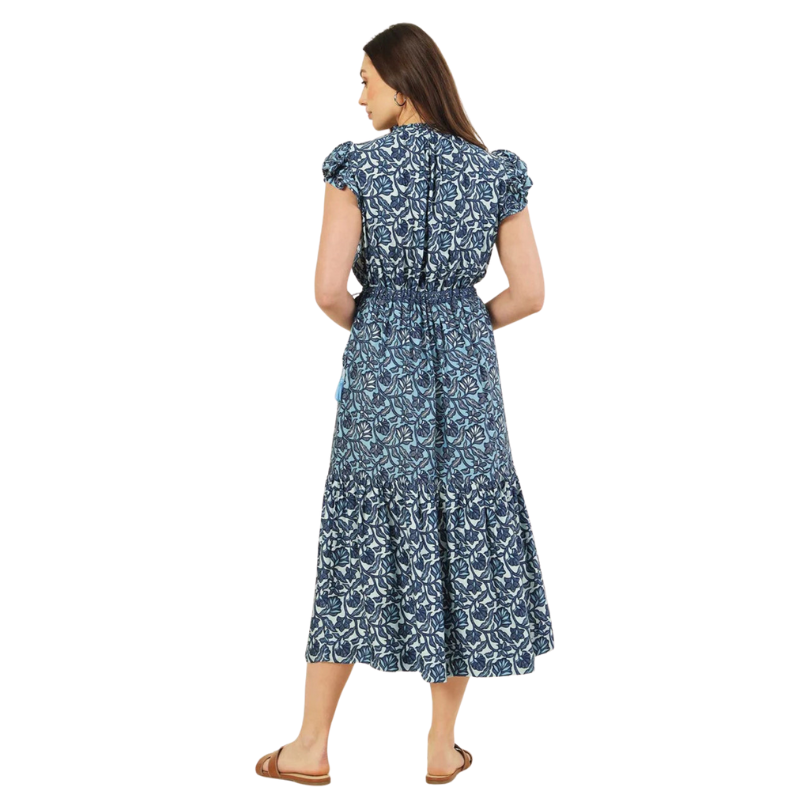 Woman wearing a blue floral dress on a white background