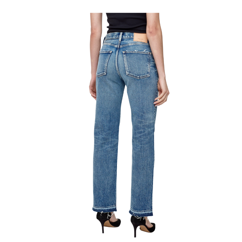 Person wearing blue jeans on a white background