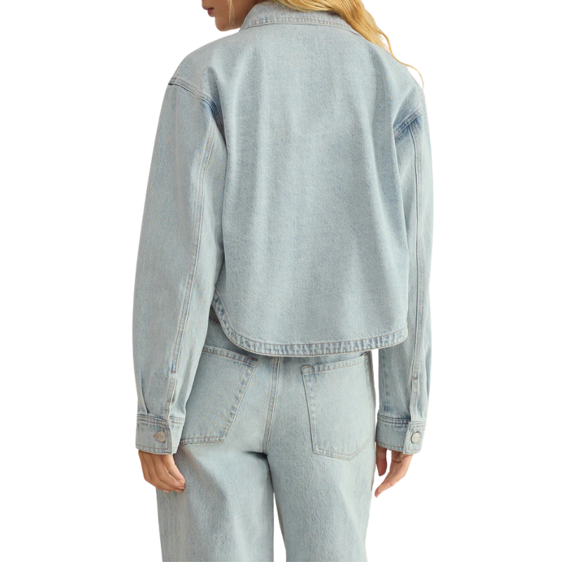 Light blue denim jacket worn by a person on a white background