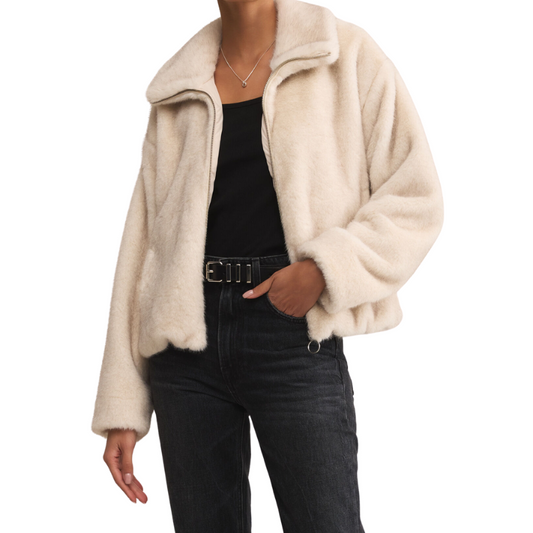 Beige fleece jacket worn by a person on a white background