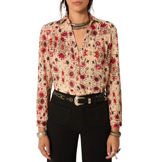 Woman wearing a floral blouse with red and black patterns on a white background