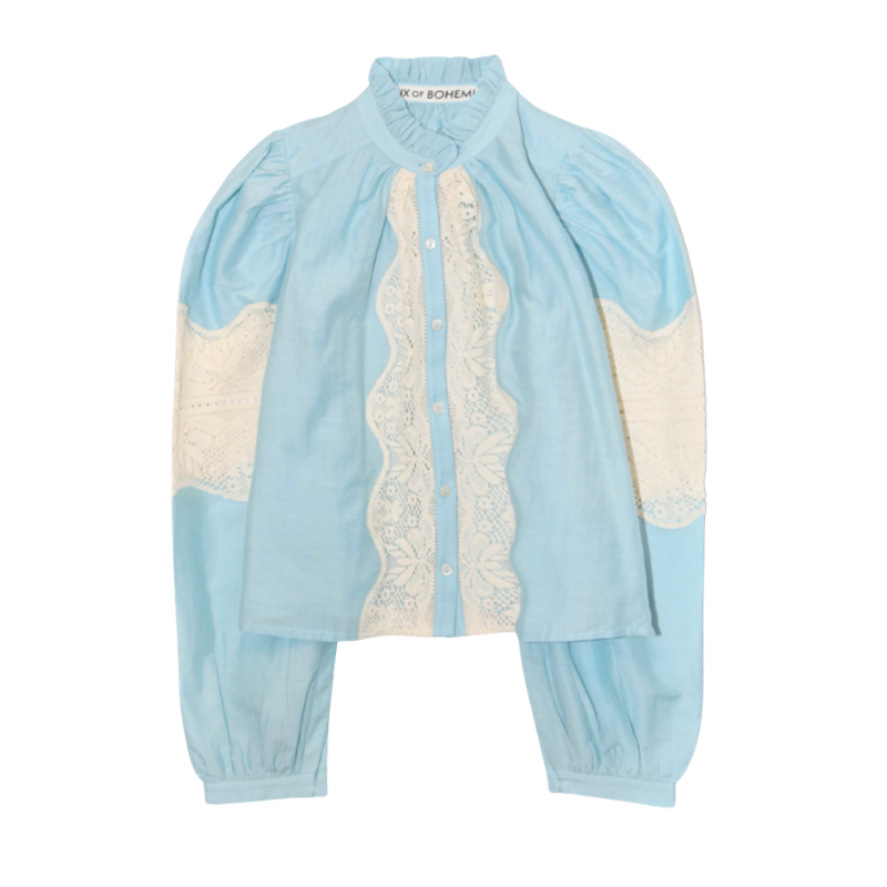 Light blue and white outfit with lace details on a white background