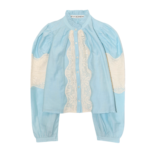Light blue and white outfit with lace details on a white background