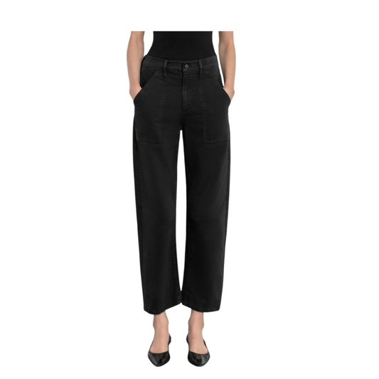 Person wearing black wide-leg jeans on a white background