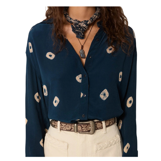 Navy blue patterned blouse with beige pants on a white background