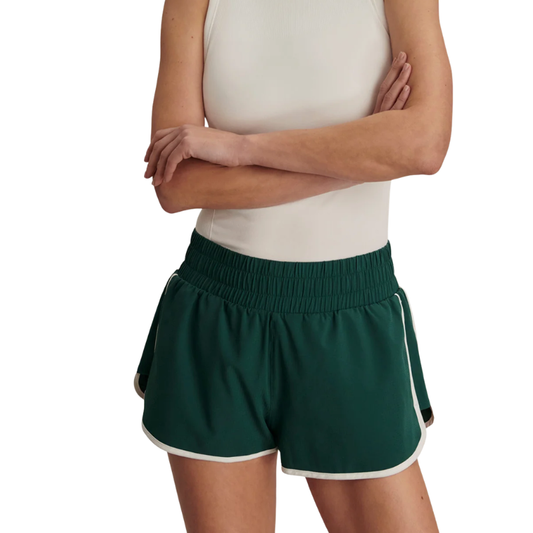 Person wearing green shorts with white trim on a white background