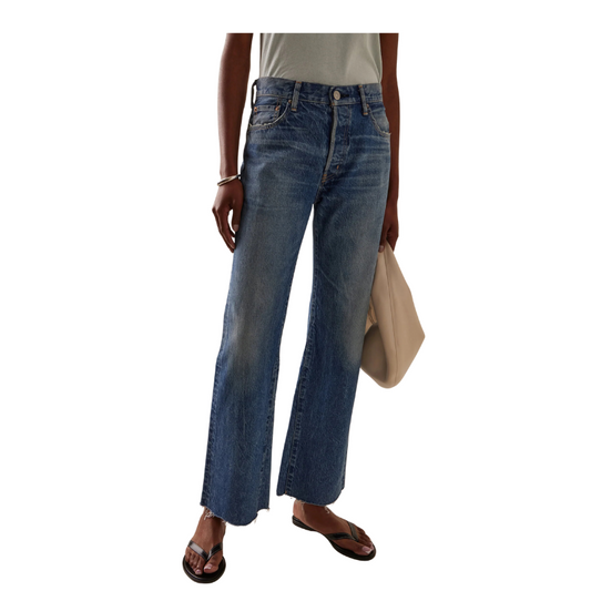 Person wearing blue jeans on a white background