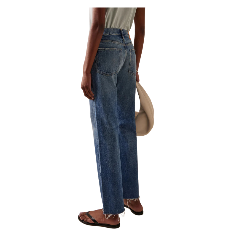 Person wearing blue jeans on a white background