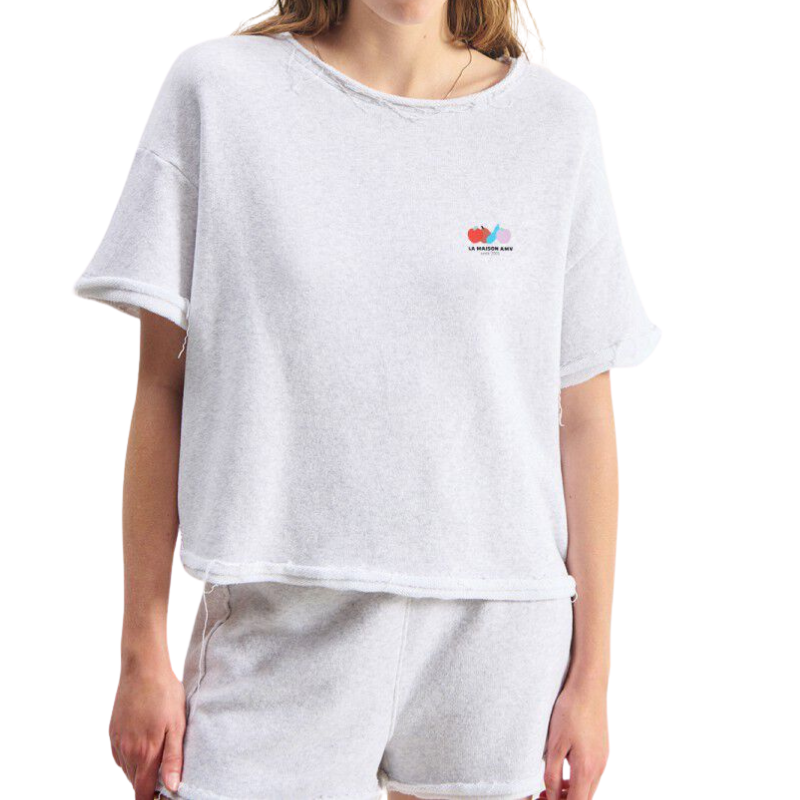 Person wearing a white t-shirt with a colorful logo on a white background