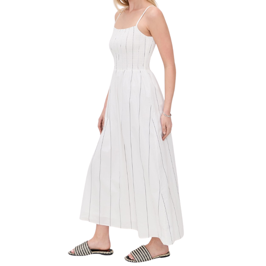 Woman wearing a white pinstripe dress on a white background
