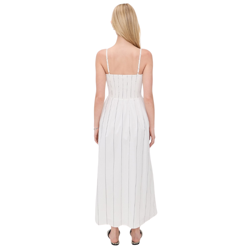 Woman wearing a white dress with thin straps on a white background
