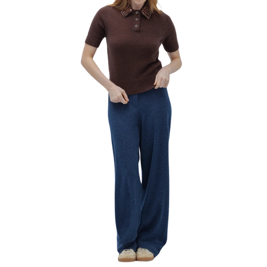 Person wearing a brown short-sleeve shirt and blue pants on a white background