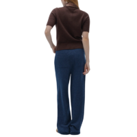 Person wearing a brown shirt and blue pants on a white background