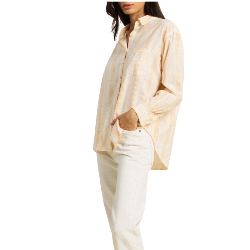 Woman wearing a beige striped shirt and white pants on a white background
