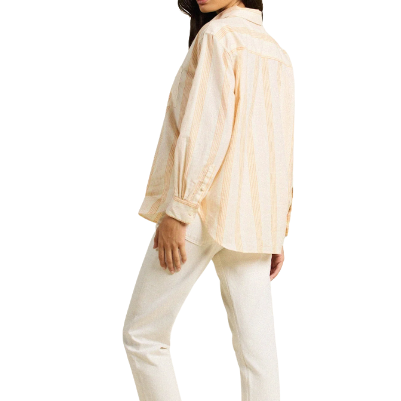 Person wearing a light-colored shirt and pants on a white background
